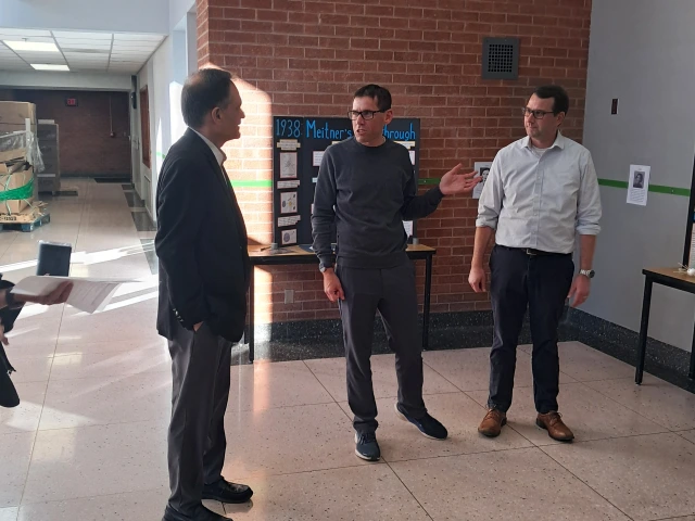 President and faculty in lobby