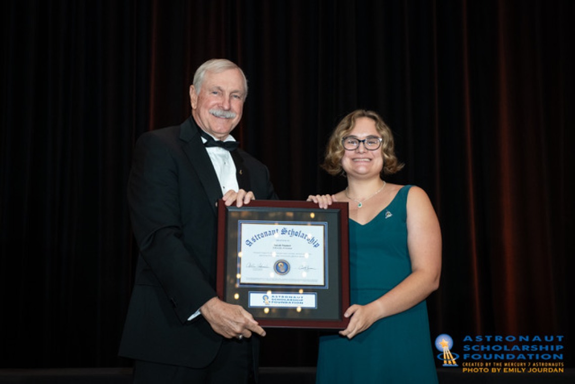 Astronaut Curt Brown presents the award to Sarah Stamer