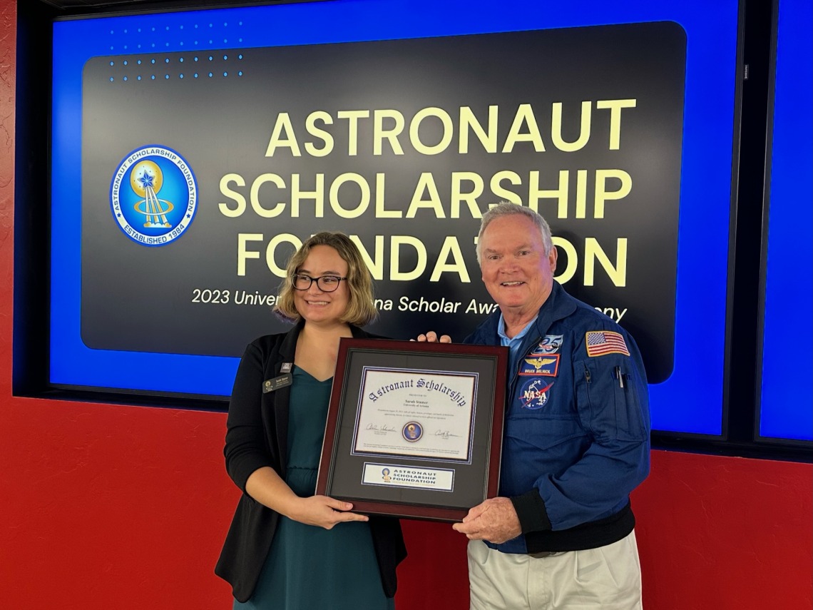 Astronaut Bruce Melnick presenting the award to Sarah Stamer.