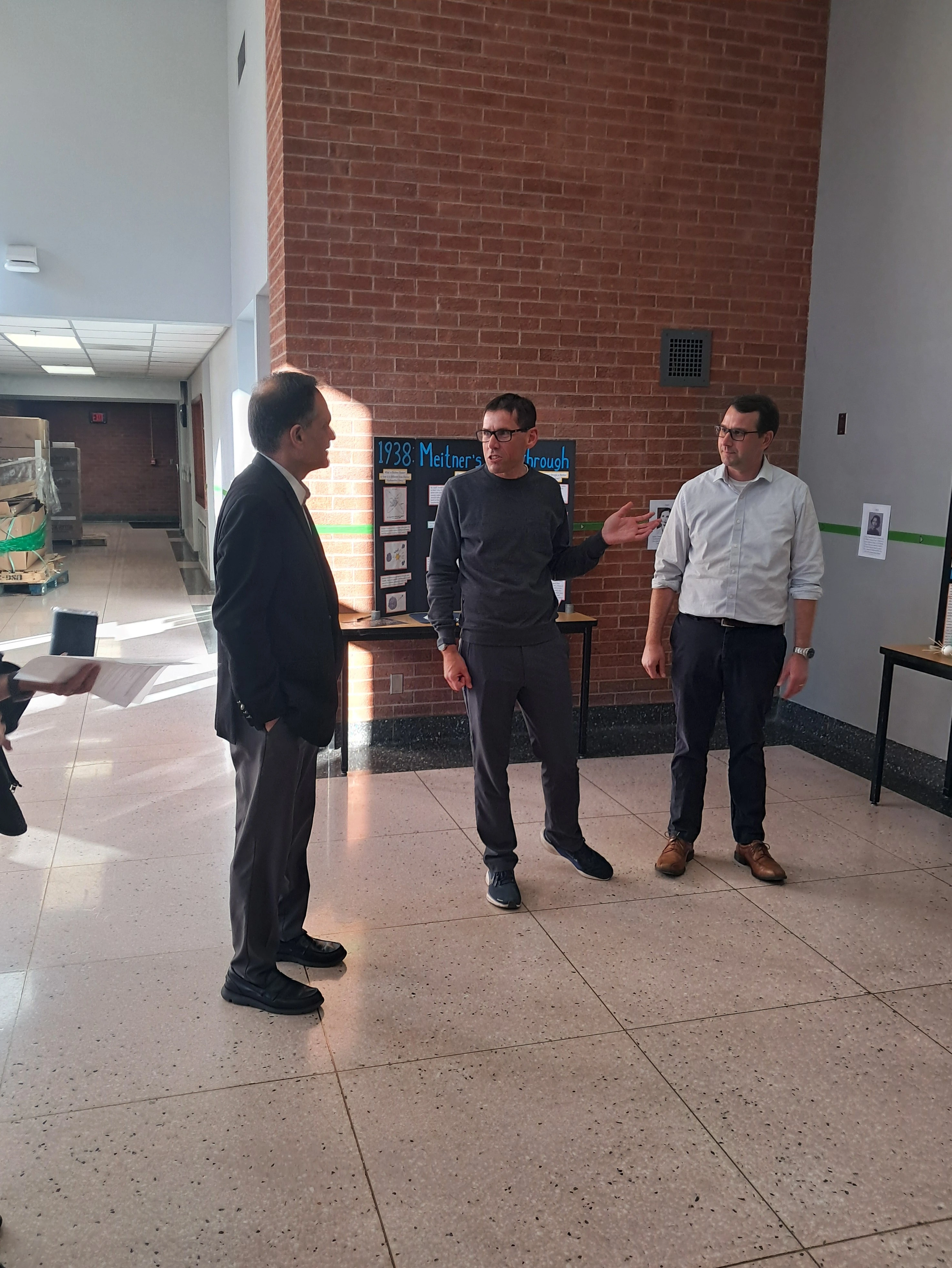 President and faculty in lobby